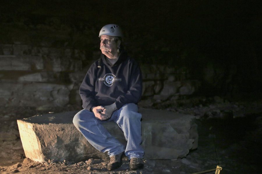 WKU Geology and Geography Professor Dr. Chris Groves sits in Crumps Cave, where he and other colleagues researched hydrology, ecology, archeology, geology and biology in 2015. The biological focus of their research was white nose syndrome – a disease threatening the lives of the federally endangered gray bats – which was discovered in Crumps Cave.
