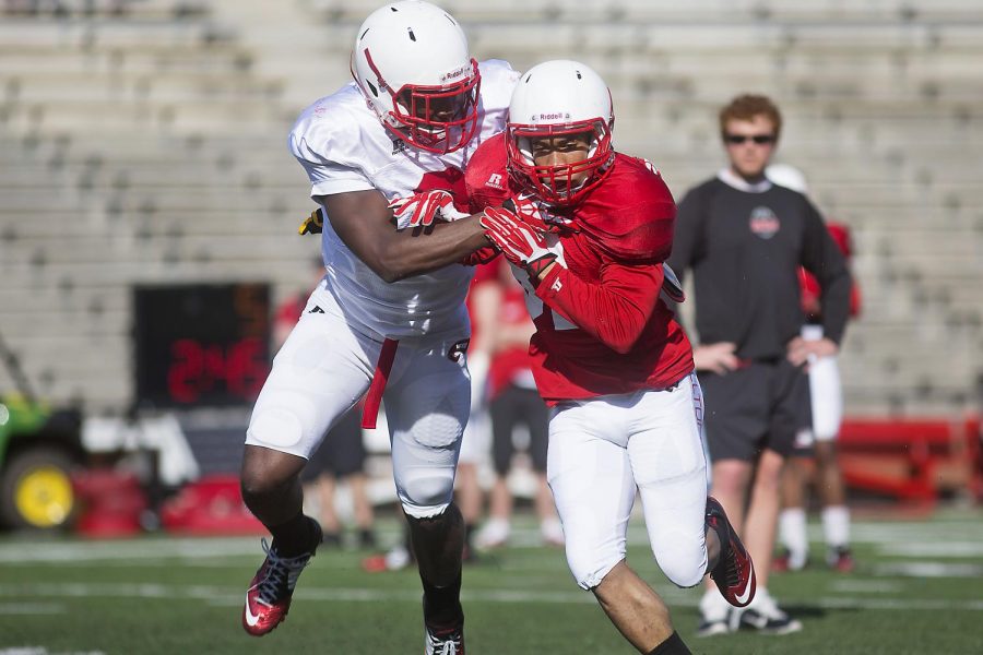 WKU junior defensive back Marcus Ward (L) and redshirt sophomore wide receiver Kylen Towner (R) fight for position during a route running drill during the teams open practice Wednesday April 1, 2015 at L.T. Smith Stadium. (Luke Franke/Herald)
