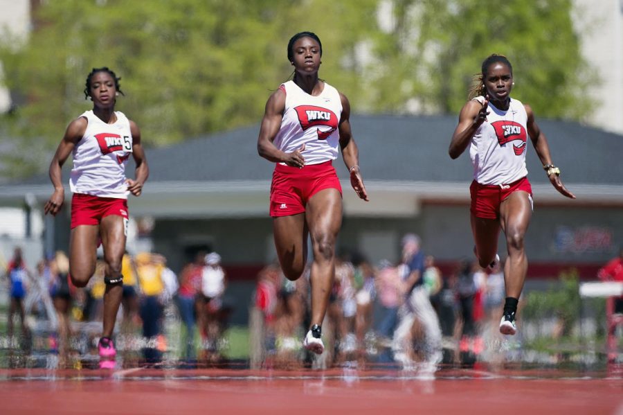 WKU sophomore Carorol Hardy, center, leads fellow Topper sprinters Sandra Akachukwu, left, and Peli Alzora in the 100-meter dash during the Hilltopper Relays in Bowling Green, Ky., on Saturday, April 11, 2015.Nick Wagner/HERALDNick Wagner/HERALD