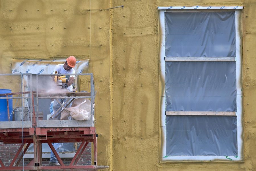 A construction worker cuts wood for the new WKU Honors College and International building that is being built on campus the Harrison Hill/HERALD