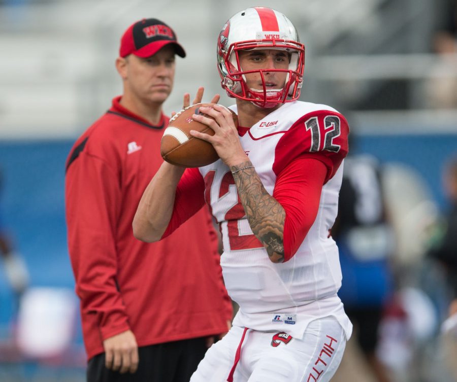 Head Coach Jeff Brohm watches quarterback Brandon Doughty in warmups before the WKU vs Middle Tennessee State University game on Sept. 13, 2014. Nick Wagner/HERALD