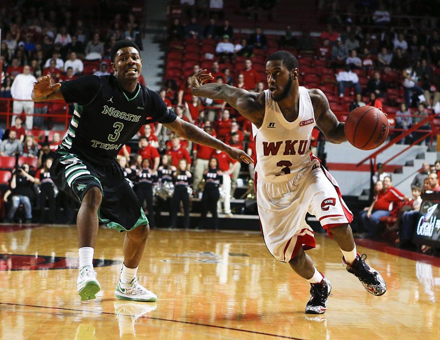 Western Kentucky University senior Trency Jackson drives past North Texas sophomore DeAndre Harris during WKUs victory against North Texas on Thursday Feb. 5, 2015. Photo by Harrison Hill/ WKU HERALD