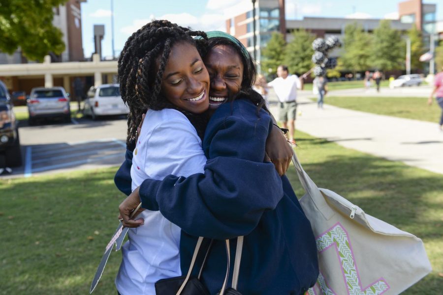 Destiny Stark, right, of Providence, Kentucky embraces her friend Dani Chavis, 21, of Belleville, Illinois, after Chavis, along with other women, was inducted into the new Delta Zeta sorority during their inaugural bid day, Sunday, Sept. 13. Stark acted as a Friends of Delta Zeta (FODZ) which is a position for friends, administrators and other greek members to support the induction of the new members. Katie Roberts/HERALD