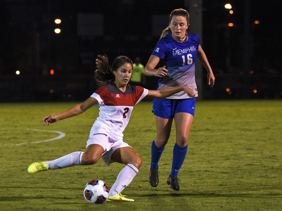 WKU midfielder Hannah Chua (2) moves the ball downfield as Memphis University defender Olivia Gauthier (16) challenges her during the second half of the Lady Toppers 2-1 win Friday night at the WKU Soccer Complex. Chua scored from outside the box late in the match to give the Lady Tops the win.