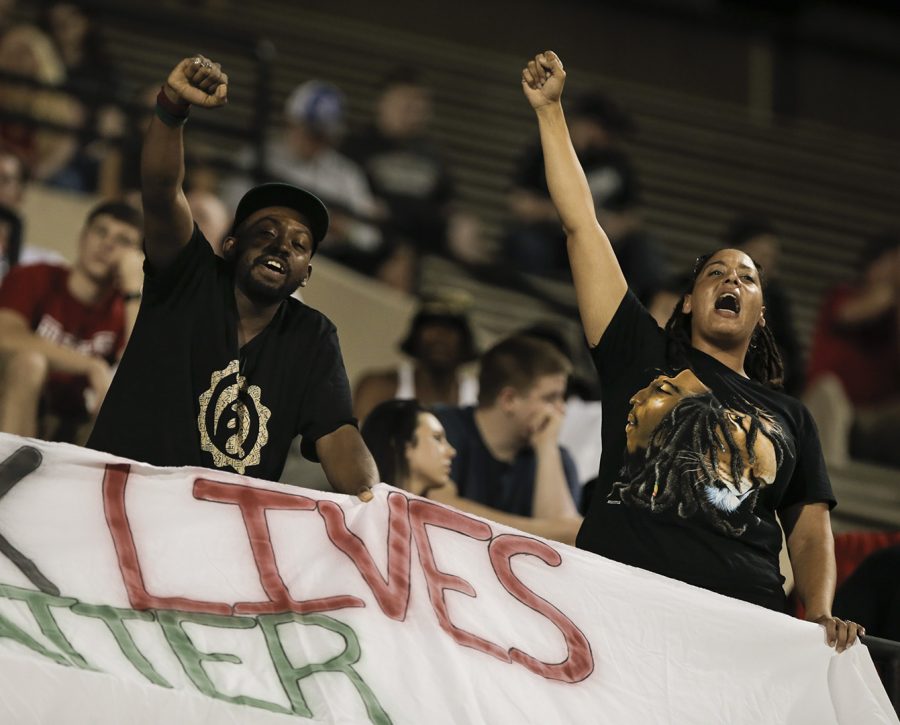 Graduate+student+Sarah+Williams%2C+right%2C+and+Rico+Thompson+chant+Black+Lives+Matter+during+the+Louisiana+Tech.+game%2C+Thursday%2C+garnering+the+attention+of+some+people+in+attendance.+While+most+of+the+crowd+cheered+as+the+Hilltoppers+played%2C+Williams+and+Thompson%2C+along+with+other+individuals%2C+chose+to+demonstrate.+Williams+said+there+is+no+established+group+behind+the+act%2C+just+a+student+led+initiative+to+bring+the+Black+Live+Matter+movement+to+WKU.+Alyse+Young%2FHERALD