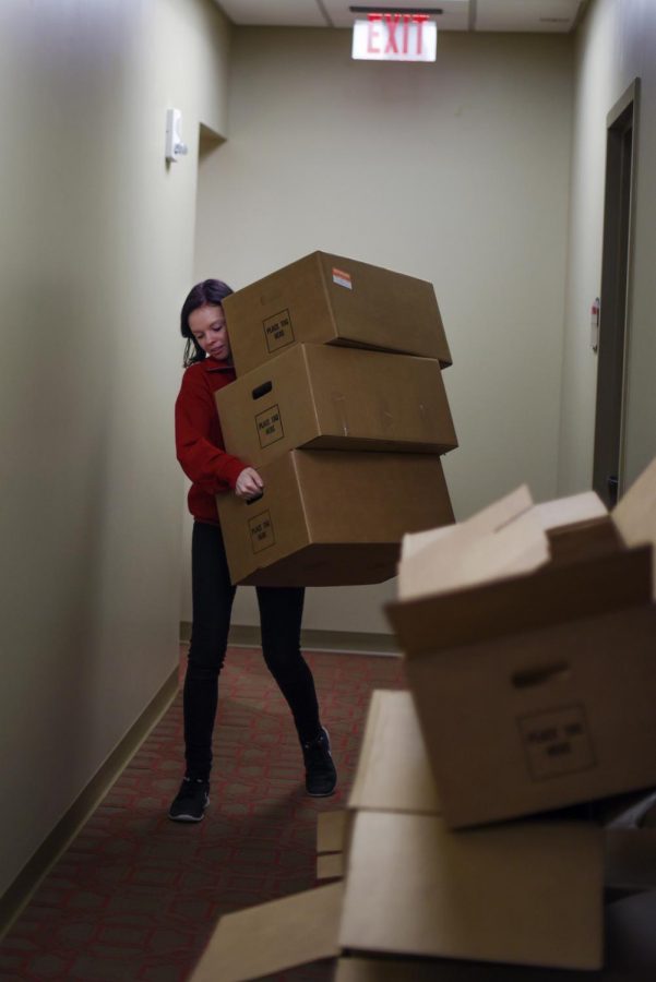 Senior student assistant Tara Sorrels moves and organizes boxes in a newly opened office at the Honors College and International Center building Wednesday. ''The building really adds to everything we try to do in the Honors College,