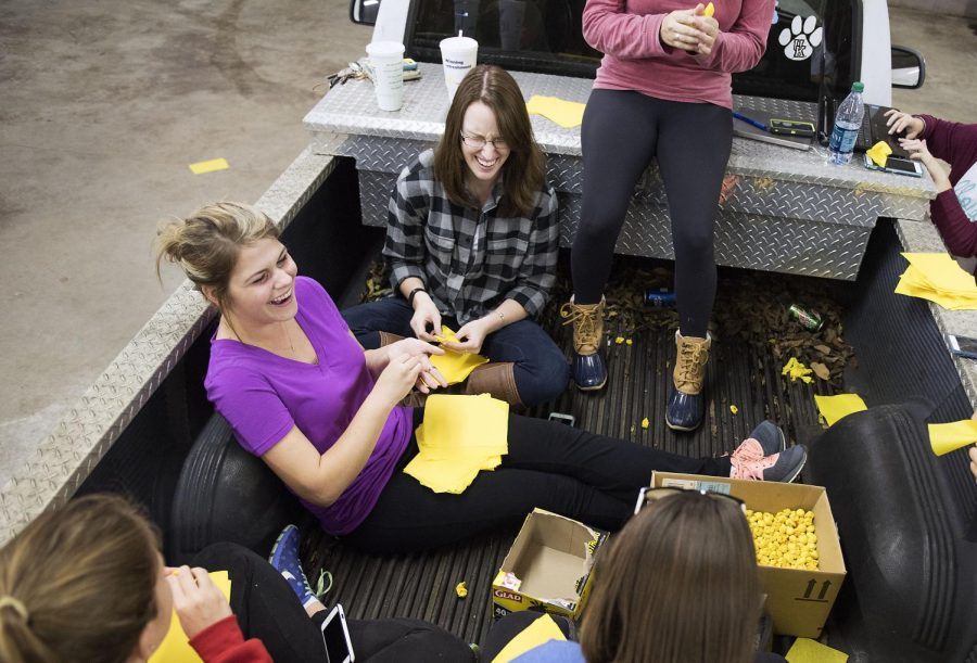 Members of Alpha Gamma Delta create pompoms from tissue paper for their Homecoming float. An estimated 10,000 pieces of tissue paper will be formed into pompoms for the parade floats. Matt Lunsford/HERALD