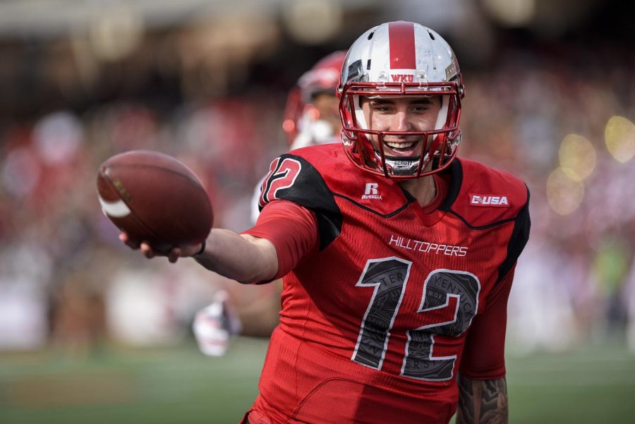 WKUs quarterback Brandon Doughty (12) celebrates catching a touchdown pass on a trick play during the Hilltoppers 35-19 win over Florida Atlantic University on Saturday at Smith Stadium.