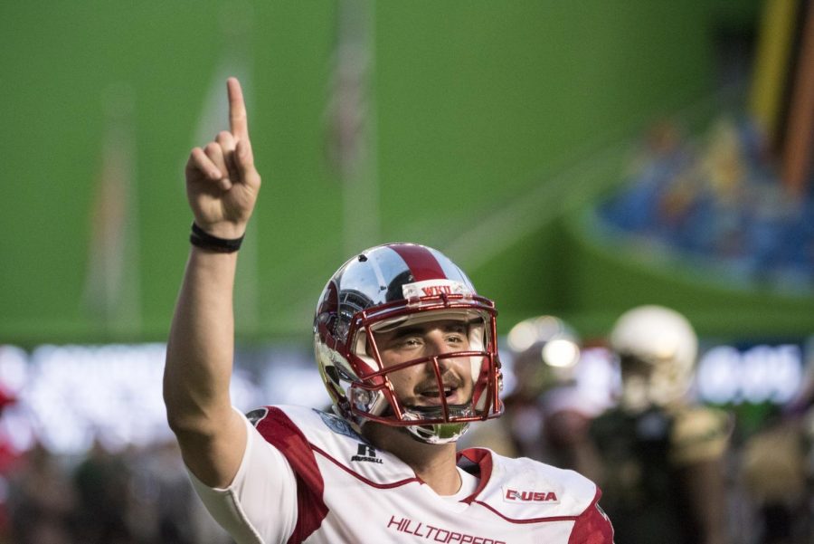 WKUs quarterback Brandon Doughty (12) celebrates a touchdown during the Hilltoppers 45-35 win over the University of South Florida in the Miami Beach Bowl on Monday at Marlins Park in Miami, Fl. Mike Clark/HERALD