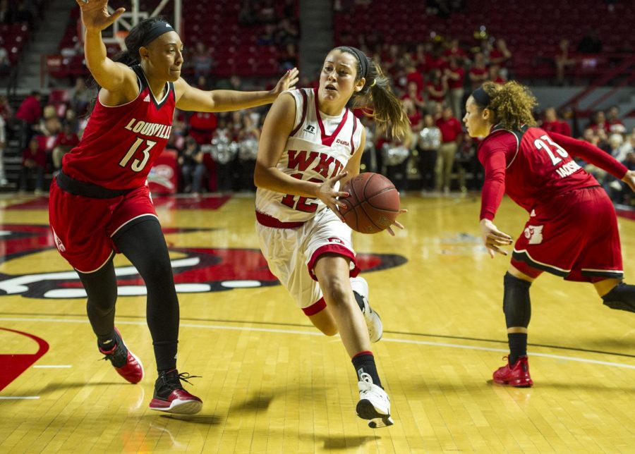 WKUs guard Kendall Noble (12) drives to the basket past Louisville forward Cortnee Walton (13) during the Lady Hilltoppers 71-69 win on November 21, 2015 at Diddle Arena. Nick Wagner/HERALD