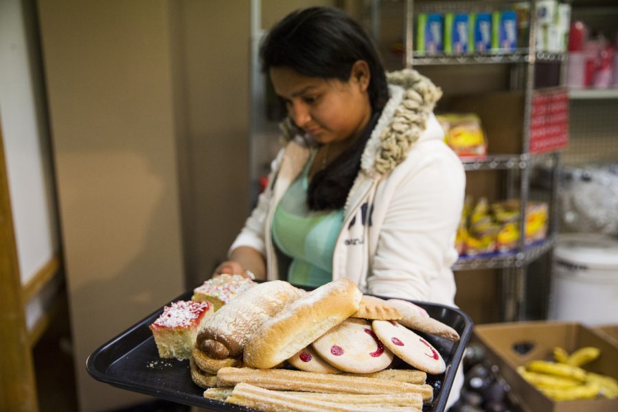 Jouana Cueas, 14 of Bowling Green holds up the tray of sweet breads she and her mother are purchasing from the bakery at Mercadito Hispano Feb. 13 in Bowling Green. I only know the name of the churros, Cueas said. This pan [bread] is for home. My mother knows all the names. Mercadito Hispano, along with the restaurant and market, offers services as a bakery and butcher shop as well. Joseph Barkoff/HERALD