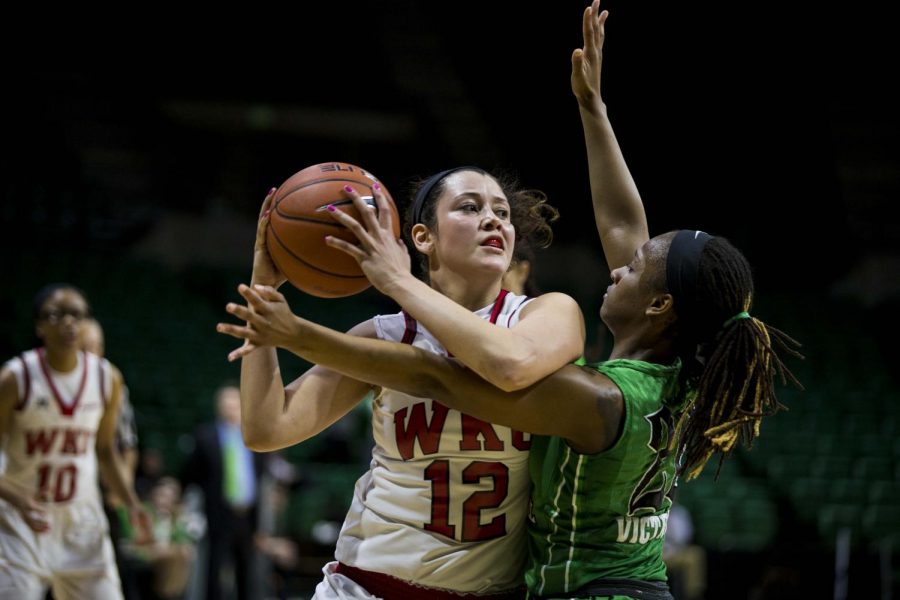 WKUs guard Kendall Noble (12) is closely guarded by Marshalls guard Norrisha Victim (20) during the final seconds of the Lady Toppers 63-66 loss in the quarterfinals of the C-USA tournament Thursday at Bartow Arena in Birmingham, Ala. Mike Clark/HERALD