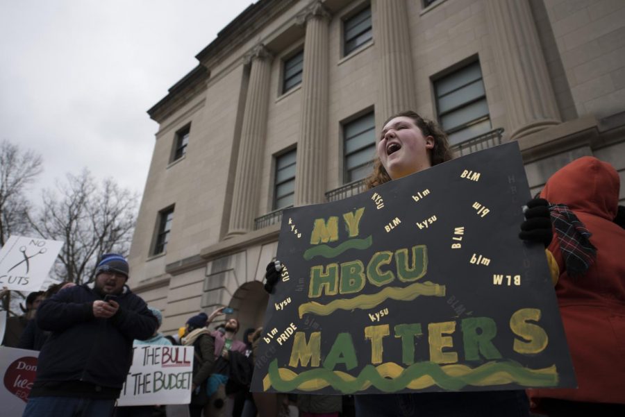 Kentucky State University sophomore Kelsey McCormick holds a sign during the March for Higher Education on Thursday on the steps of the Kentucky State Capital Annex in Frankfort. The march was to protest Gov. Matt Bevin's proposed budget which calls for a 9 percent reduction in state funding for public universities. Mike Clark/HERALD