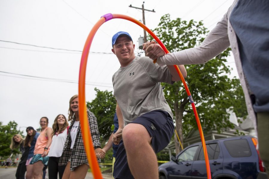 Participants in the Rue De La Rouge street festival attempt to break Guinness world record of the largest hula hoop chain on Friday April 29, 2016 on College Street in Bowling Green. The current wold record is 572 participants, but there were about 106 participants in todays attempt. 