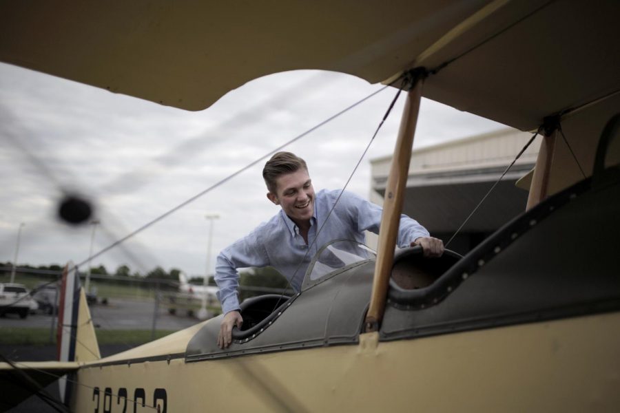 Nashville senior Colin Perschbacher climbs into a replica of a 1917 Curtis Jenny outside a hangar at the Bowling Green Airport on May 3. The biplane took three years to replicate and is covered in a polyfiber cloth instead of Irish linen to make yearly maintenance a little easier. Lex Selig/HERALD