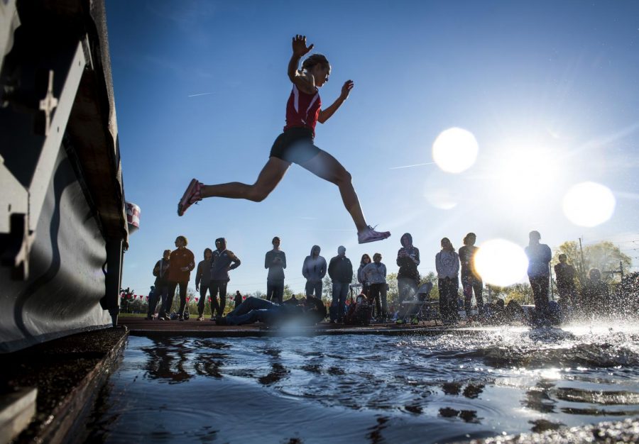 Runners fly high as they leap the water obstacle on the women's 3000-meter steeple chase at the Hilltopper Relays on April 9. They must complete eight laps of the track, overcoming multiple hurdles and the water trap. Gabriel Scarlett/HERALD
