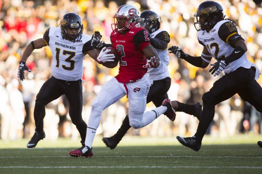 WKUs wide receiver Taywan Taylor (2) rushes the ball past Southern Mississippi University defensive back Picasso Nelson Jr. (13), defensive back Cornell Armstrong (3), and wide receiver Jarell Aaron (12) during the Conference USA football Championship game between WKU and Southern Mississippi University on Saturday Dec. 5 at L. T. Smith Stadium in Bowling Green, Ky. Shaban Athuman/HERALD