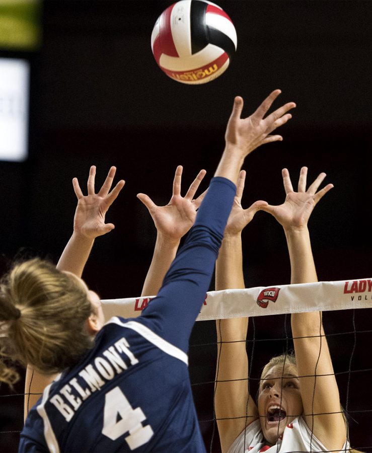 Sophomore outside hitter Taylor Dellinger (21) jumps up to block a shot from Belmonts outside hitter Maggie Mullins (4) during WKUs 3-0 victory on Tuesday, Sept. 6 at Diddle Arena. Matt Lunsford/HERALD