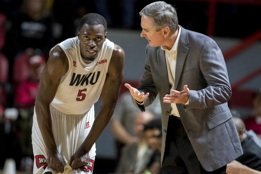 Head coach Rick Stansbury talk to Junior Lomomba (5) during the Hilltoppers 103-97 double overtime win over Kentucky Wesleyan College on Saturday Nov. 5, 2016 at E.A. Diddle Arena.