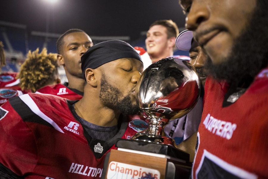 Redshirt senior wide receiver Stephon Brown (17) kisses the Boca Raton Bowl trophy after WKUs 51-31 win over the University of Memphis in the Boca Raton Bowl on Tuesday, Dec. 20, 2016, at FAU Stadium in Boca Raton, Fla.