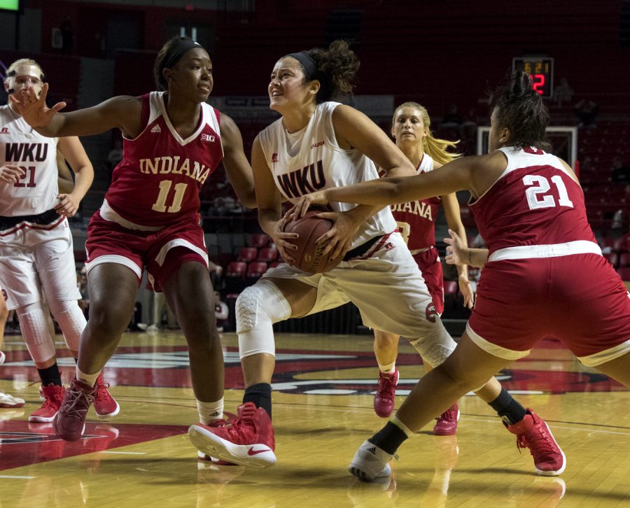 Redshirt+senior+guard+Kendall+Noble+%2812%29+drives+to+the+basket+while+Indiana+Universitys+guard+Karlee+McBride+%2821%29+and+forward+Kym+Roster+%2811%29+guard+her+during+the+Lady+Toppers+85-74+win+Nov.+19%2C+2016+in+Diddle+Arena.+Evan+Boggs%2FHERALD