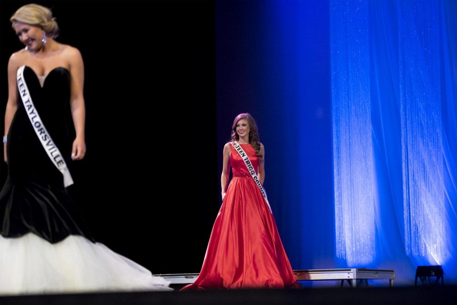 MacKayla Phillips (Trigg County) waits as Taylor Flake (Taylorsville) shows off her gown in the evening gown portion of the Miss Kentucky United States pageant on Saturday, Feb. 25, at Van Meter.