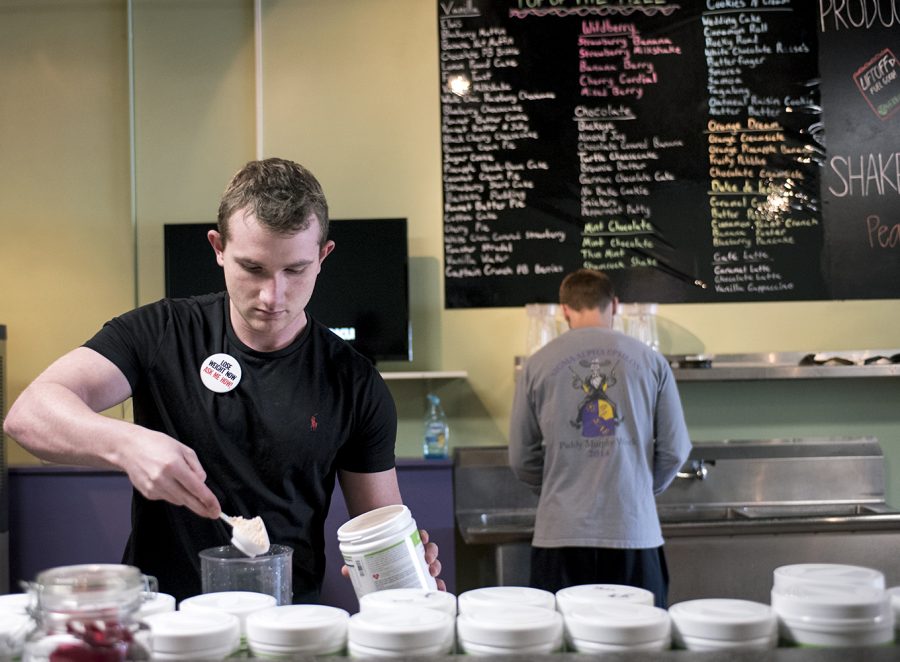 Austin Sutcliffe prepares a banana berry shake at Top of the Hill Nutrition on March 20.The business has been open for two weeks and serves a variety of low calorie meal replacement shakes.