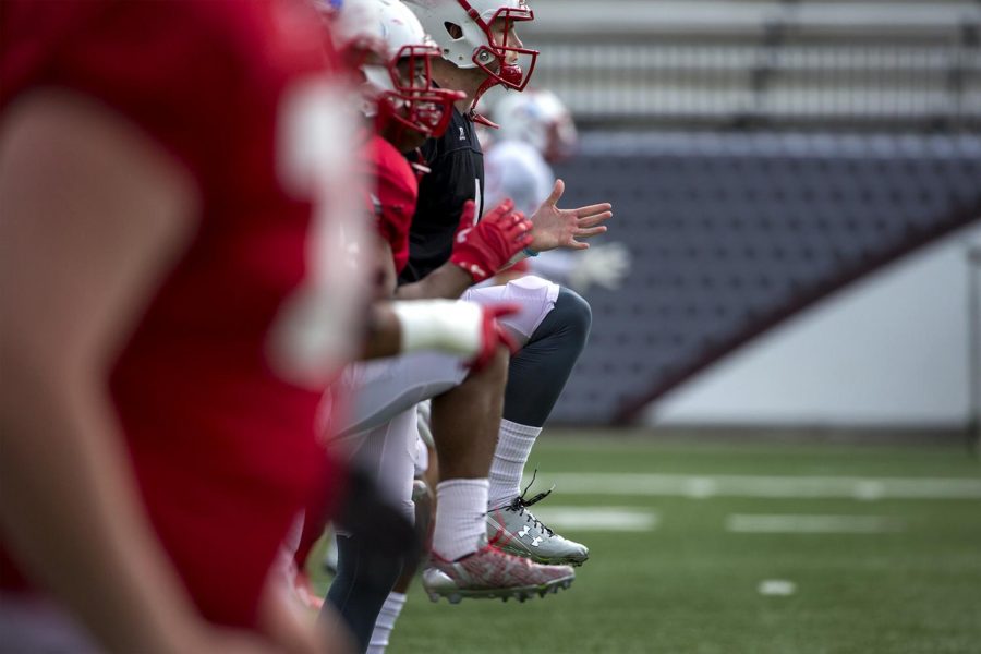 WKU football players do high-knee drills before going through their plays during practice on Tuesday at L.T. Smith Stadium. 
