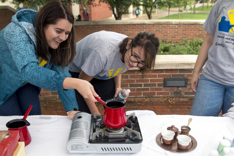 Puracic, Bosnia graduate Dzenana Kadric, 22 (left), and Sarajevo, Bosnia senior Sanida Palavra, 21 (right), prepare the traditional Bosnian coffee on Monday, Aug. 28 in Centennial Mall during the Year of Bosnia Kickoff event where students and faculty could stop by the tents and enjoy coffee and cookies while learning about Bosnian traditions.