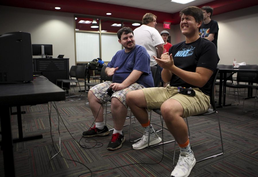 Sellersburg, Ind. sophomore Stephen Green, 19, (right) loses a rock, paper, scissors match against Bowling Green local Nick Kafogolis, 30, (left) before starting a Super Mario Smash Bros. Melee during one of Gamers Guild tournaments on Friday, Sept. 15 in DSU. Kathryn Ziesig/HERALD