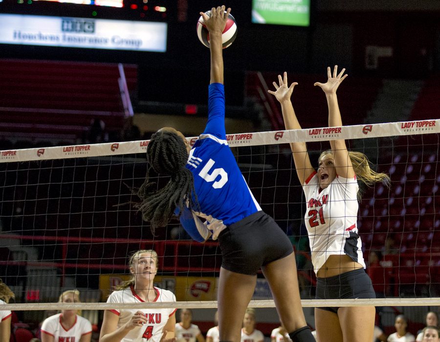 Junior Taylor Dellinger (21) goes up to block Tennessee State Rachel Henderson (5), during WKUs game on Tuesday night in Diddle Arena. WKU womens volleyball won their first home game against Tennessee State on Tuesday in Diddle Arena.