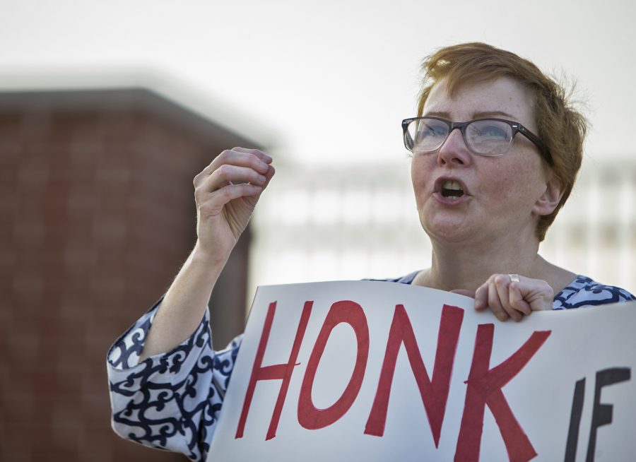 Maureen Davis, the rally organizer, speaks to the group of protestors outside of Mitch McConnells office on Friday, Sept. 22 in downtown Bowling Green. The group was protesting the GOPs latest healthcare bill. Daviss sign read Honk if you want to ditch Mitch.