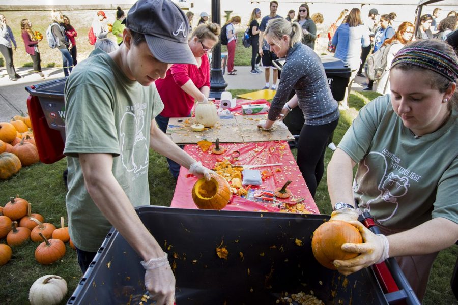 Members of Potter College of Arts and Letters empty out the insides of pumpkins to be used for flower arranging at the Potter College Fall Festival on Wednesday, Oct. 18. Other activities included metal pouring, face painting, giant Jenga and live performances.
