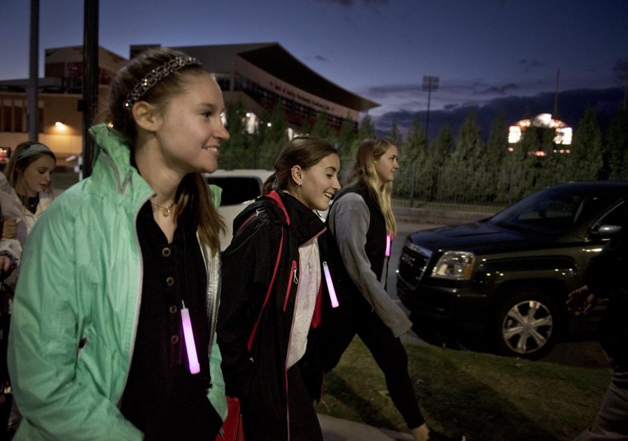 BreeAnn Burgess (left), a junior from Owensboro, participates in the Glow Walk benefitting the American Cancer Society on WKU’s campus Tuesday, with junior Sydney Fones of Bowling Green (center). 