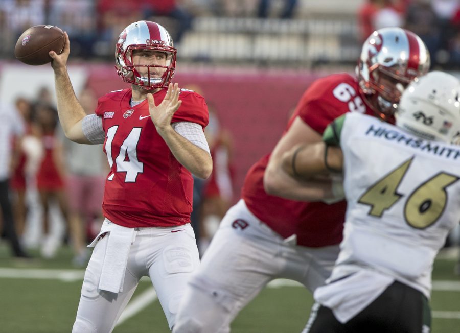 WKU+quarterback+Mike+White+%2814%29+spots+an+open+teammate+for+a+pass+at+the+WKU+Homecoming+football+game+on+Saturday+at+Houchens-Smith+Stadium.