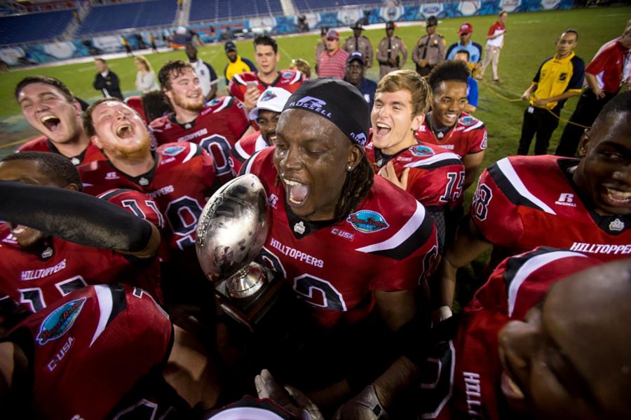 WKU offensive lineman Darrell Williams Jr. (62) holds on to the Boca Raton trophy after the Hilltoppers 51-31 win over Memphis on Tuesday, Dec. 20, 2016 at FAU Stadium in Boca Raton, Fla.