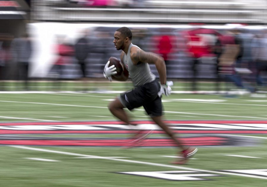 Former wide receiver Nacarius Fant (1) runs downfield rout after catching a pass from quarterback Mike White (14) during the annual NFL Pro Day in Houchens-Smith Stadium on Friday, March 30. In the 2017 season Fant caught 704 yards receiving.