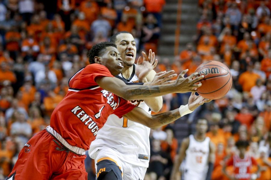 WKU guard Lamonte Bearden (1) and Oklahoma State Cowboys guard Kendall Smith (1) battle for a loose ball during NIT quarterfinal game between the Oklahoma State Cowboys and the Hilltoppers at Gallagher-Iba Arena in Stillwater, Okla. on Wednesday, March 21st, 2018. 