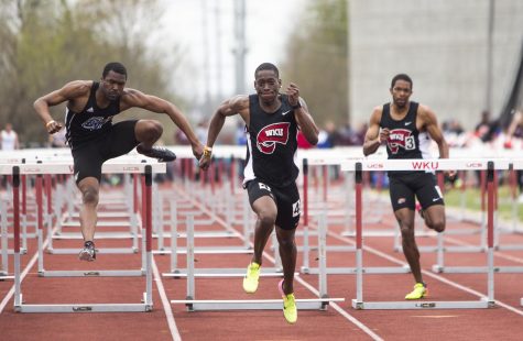 Johnathan Hayden (center) runs toward the finish line after toppling the last hurdle during the Hilltopper Relay event which took place on Friday, April 6 at the Charles M. Rueter Track and Field Complex. Hayden took first place in the 110m hurdles.