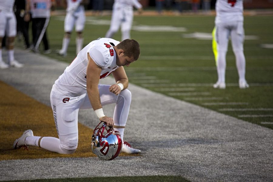 Redshirt junior punter Jake Collins kneels on the sidelines during WKUs 20-7 loss to Illinois on Sept. 9.