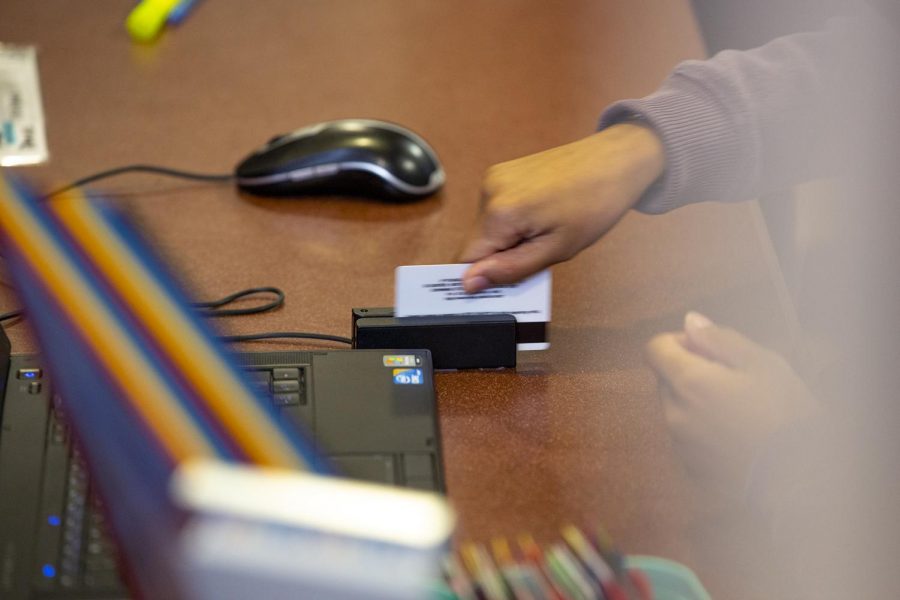 A PFT desk attendant swipes a students WKU ID on Sunday, Sept. 9, 2018.