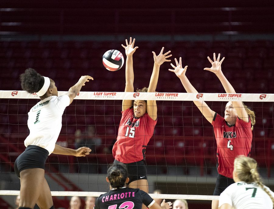 WKU's Kayland Jackson (15) and Rachel Anderson (4) go up to block during WKU's match against Charlotte at Diddle Arena on Sept. 23, 2018.