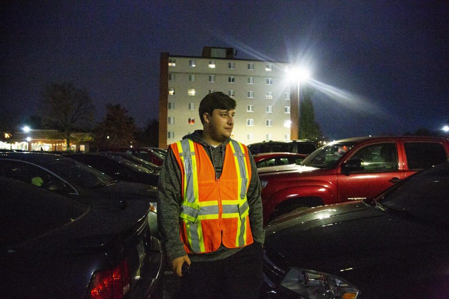 Keaton Walker, Senior, does his weekly routine of checking to see if cars are parked in the wrong lot on a Tuesday night. I always try to lend a hand to any student that needs it, Walker said.