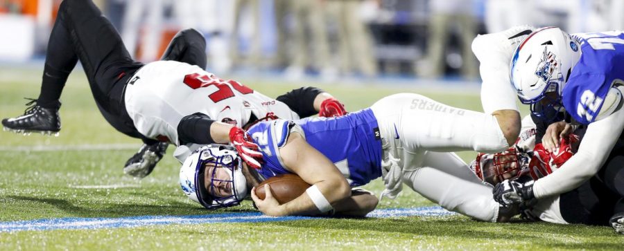 Redshirt senior defensive tackle Evan Sayner (55) tackles MTSU quarterback Brent Stockstill (12) during WKU's 29-10 loss to Middle Tennessee State University on Friday, Nov. 2, at Johnny “Red” Floyd Stadium in Murfreesboro, Tennessee.
