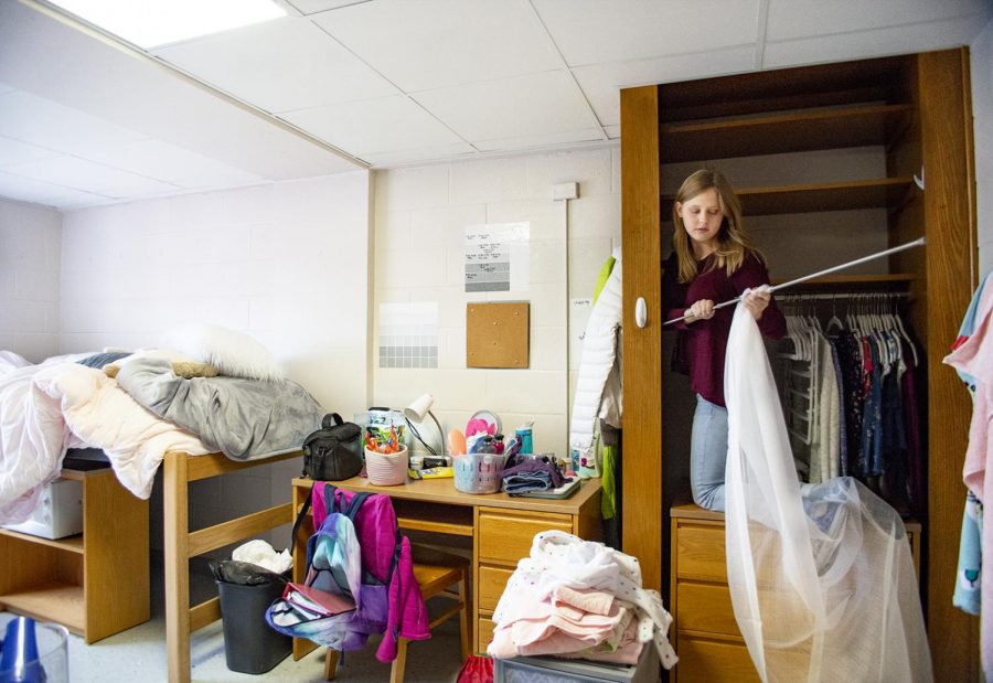 Lily disassembles her dorm room after being told Thursday she would have to evacuate the Minton Residence Hall. Her roommate had already moved out and Lily said she was concerned as to how or where she and her friends were going to hang out together after each was placed in a different dorm.