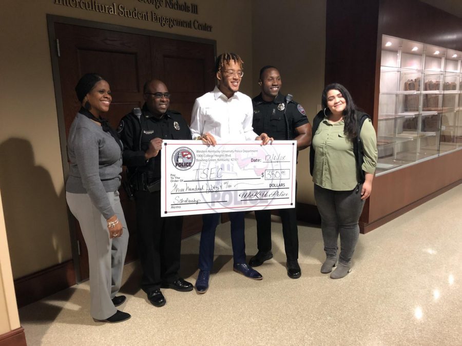 WKU freshman Darren Griggs stands holding his scholarship check with WKU Police chief Mitchell Walker and Officer Tim Gray, along with ISEC Executive Director Martha Sales and Program Coordinator Kristina Gamble. Photo by Jack Dobbs