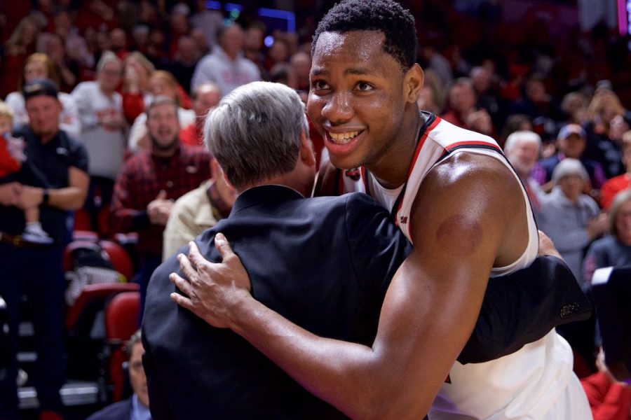 Charles Bassey (23) embraces head coach Rick Stansbury after defeating 15th-ranked Wisconsin in Diddle Arena Dec. 29 in Bowling Green. Bassey had 19 points and six rebounds in the win. 