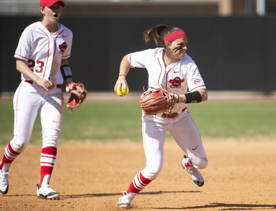 WKU senior shortstop Rebekah Engelhardt prepares to throw to first after catching an infield grounder from Charlotte at the WKU Softball Complex March 23, in Bowling Green. Behind Engelhardt, junior third base Morgan McElroy yells the whereabouts of the baserunner advancing from second to third. Engelhardt cranked in 2 runs and 3 RBIs going 2-3 at the dish in the WKU 11-2 victory.