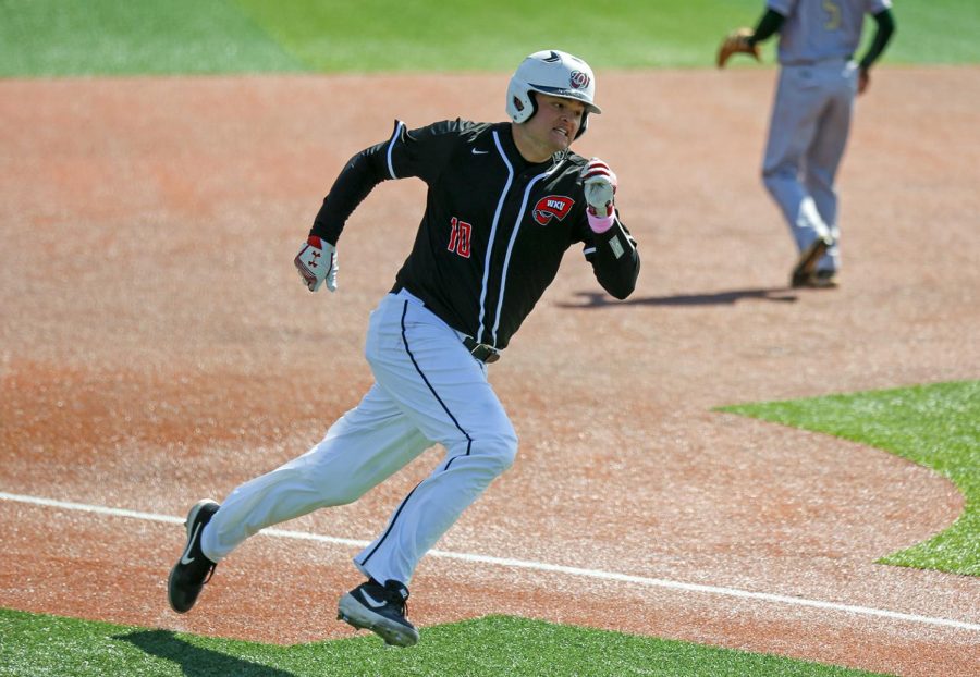 Infielder Davis Sims rounds third base heading toward home to score one run during WKUs win 5-3 against University of Alabama in Nick Denes Field on Sunday, March 17.