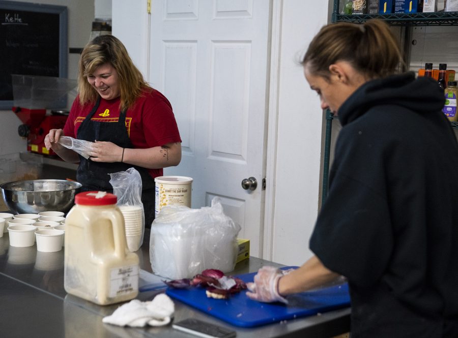 Haylie Wells, left, and Jessica Jones, right, prepare food for Beet Box. Beet Box sells products such as dips, salads, and bento boxes.